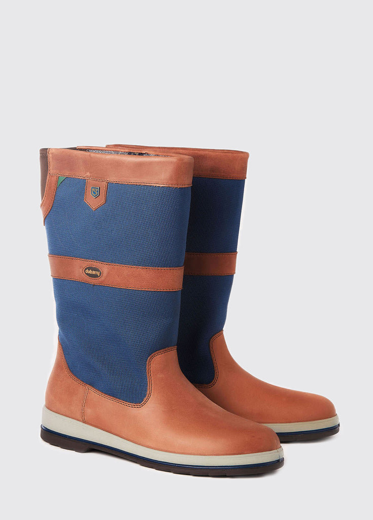 Pair of Shamrock Sailing Boots in a Navy and brown or orange colour on a grey studio background